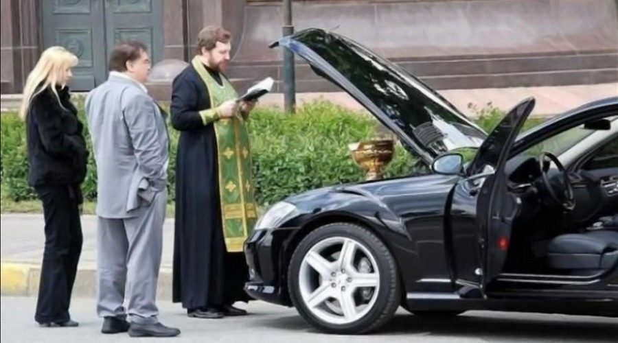 Car blessing - Orthodox priest blessing a car